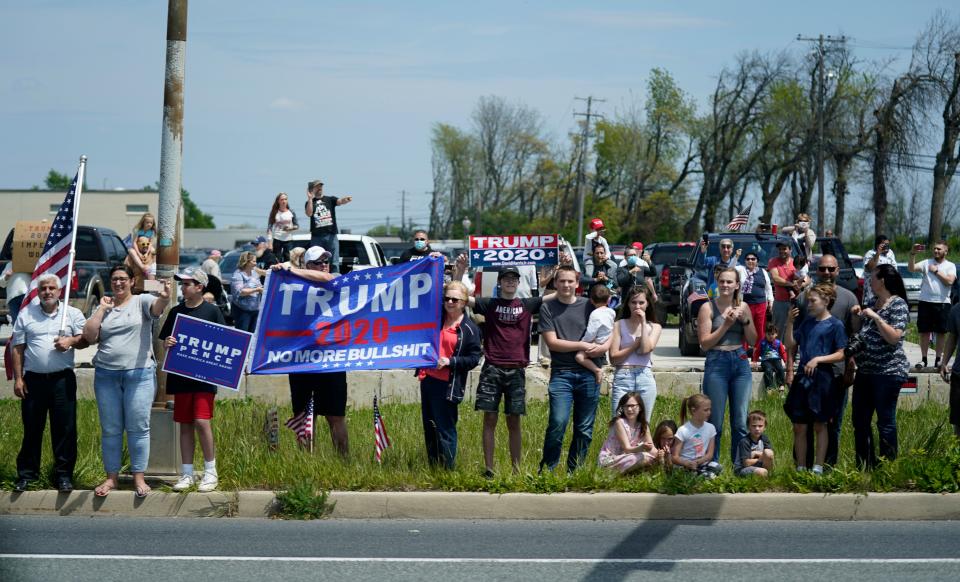 People watch as a motorcade with President Donald Trump drives past on Thursday, May 14, in Allentown, Pennsylvania. (Photo: Evan Vucci/Associated Press)