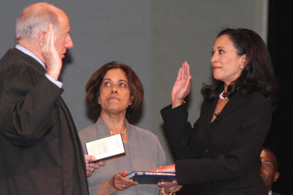 From left, then-California Supreme Court Chief Justice Ronald M. George administers the oath of office to then-San Francisco District Attorney Kamala Harris as her mother, Dr. Shyamala Gopalan, holds a copy of  the Bill of Rights.