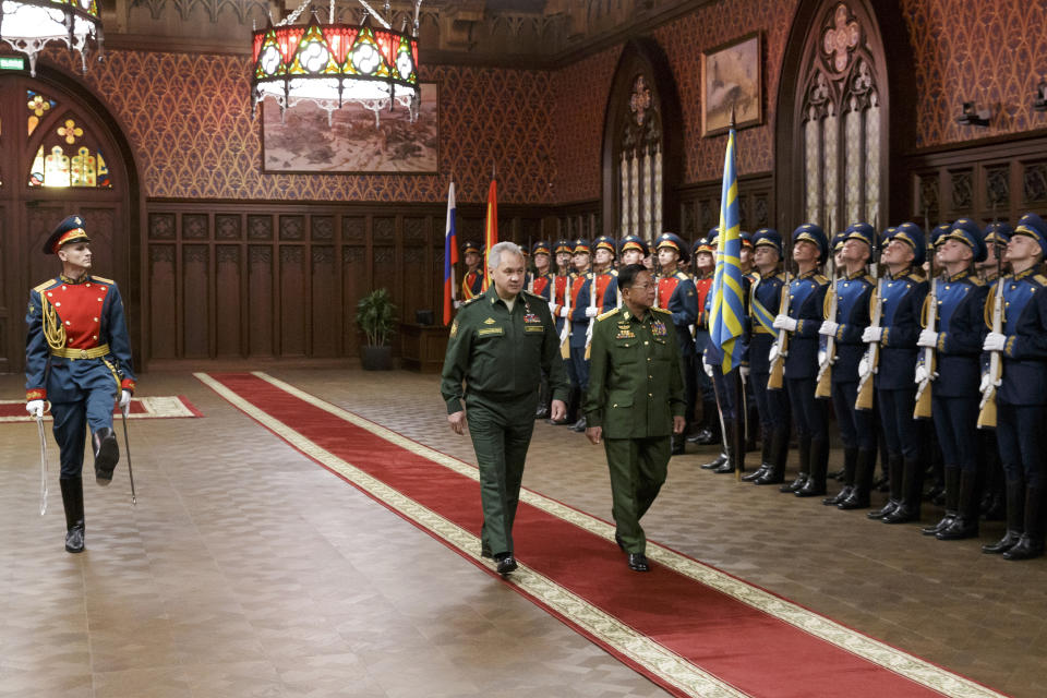 Russian Defense Minister Sergei Shoigu, left, and Commander-in-Chief of Myanmar's armed forces Senior General Min Aung Hlaing walk past the honor guard prior to their talks in Moscow, Russia, Tuesday, June 22, 2021. (Vadim Savitskiy/Russian Defense Ministry Press Service via AP)