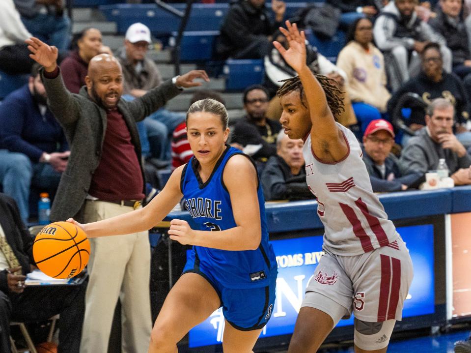 Shore Rylee Drahos races down the side line as she’s guarded by University Destiny Bynum-Johnson.  University defeats Shore Regional in NJSIAA Group 1 Championship game in Toms River on March 5, 2023. 