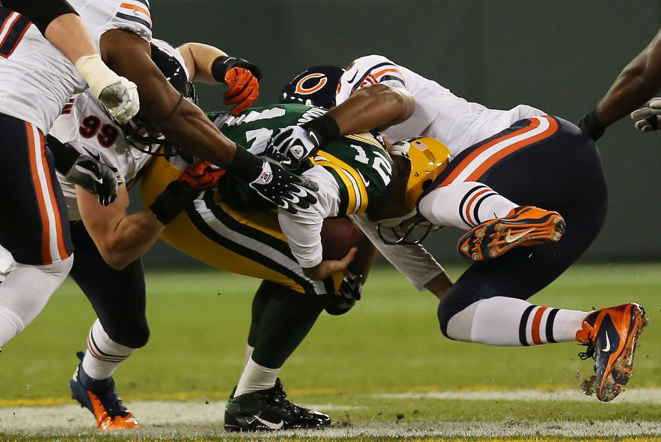 GREEN BAY, WI - SEPTEMBER 13: Quarterback Aaron Rodgers #12 of the Green Bay Packers is sacked by defensive tackle Amobi Okoye #91, defensive end Shea McClellin #99 and defensive end Corey Wootton #98 of the Chicago Bears during the first quarter at Lambeau Field on September 13, 2012 in Green Bay, Wisconsin. (Photo by Jonathan Daniel/Getty Images)