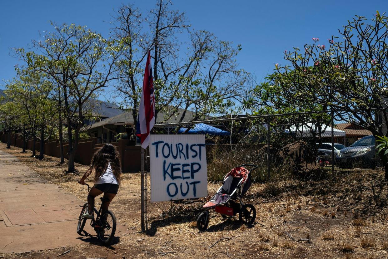 Long before a wildfire blasted through Maui, there was tention between Hawaii's longtime residents and the visitors some islanders resent for turning their beaches, mountains and communities into playgrounds.