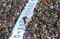 Jimmie Johnson greets fans during driver introductions before the NASCAR Daytona 500 auto race at Daytona International Speedway, Sunday, Feb. 16, 2020, in Daytona Beach, Fla. (AP Photo/David Graham)