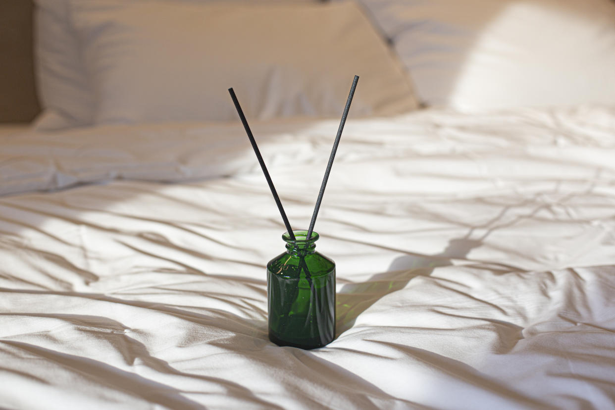 Reed diffuser of bed in room. Modern interior
