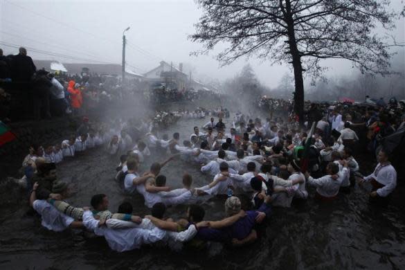 Bulgarian men dance in the icy waters of the Tundzha river during a celebration for Epiphany Day in the town of Kalofer, east of Sofia, January 6, 2012. REUTERS/Stoyan Nenov