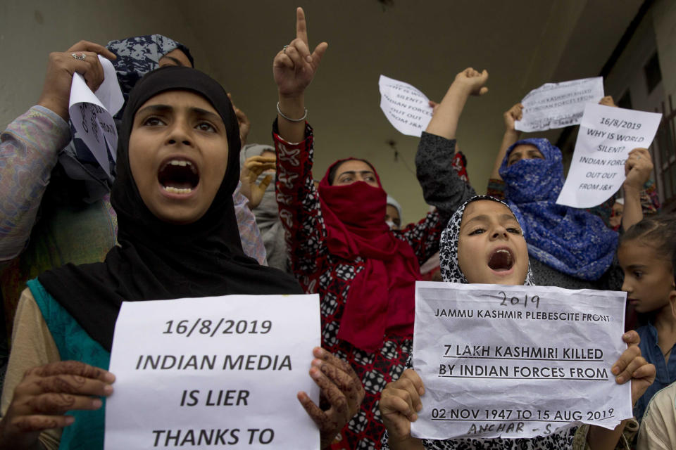 Kashmiri Muslim women and young girls hold placards and shout pro-freedom slogans during a demonstration after Friday prayers amid curfew like restrictions in Srinagar, India, Friday, Aug. 16, 2019. Hundreds of people have held a street protest in Indian-controlled Kashmir as India's government assured the Supreme Court that the situation in the disputed region is being reviewed daily and unprecedented security restrictions will be removed over the next few days. (AP Photo/Dar Yasin)
