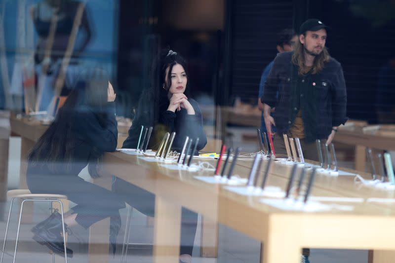 People sit inside a closed Apple Store during the global outbreak of coronavirus (COVID-19) in Santa Monica