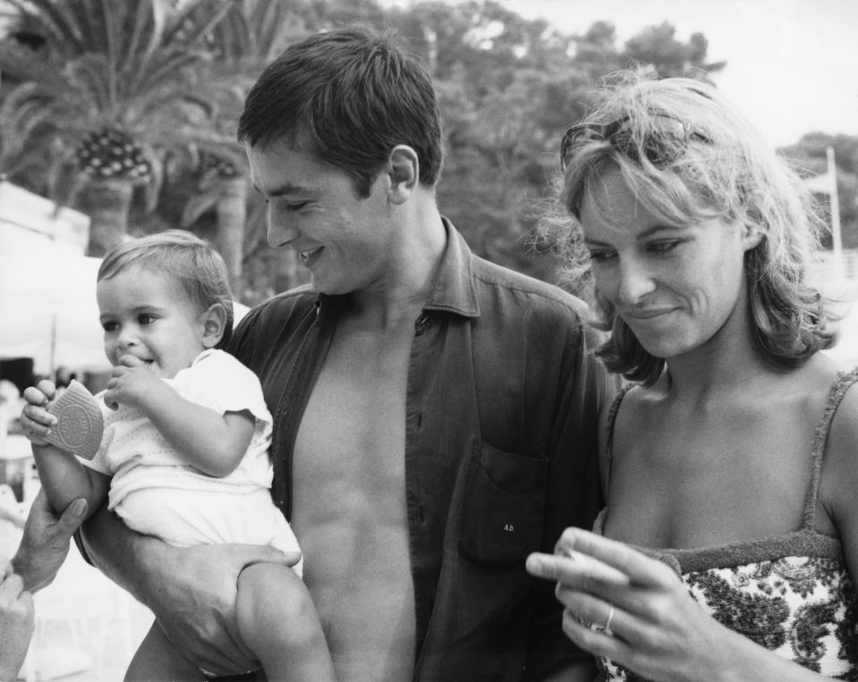 <p>French actor Alain Delon with his wife Nathalie and their son Anthony on the beach at Monte Carlo, 15th August 1965. (Photo by Archive Photos/Getty Images)</p>
