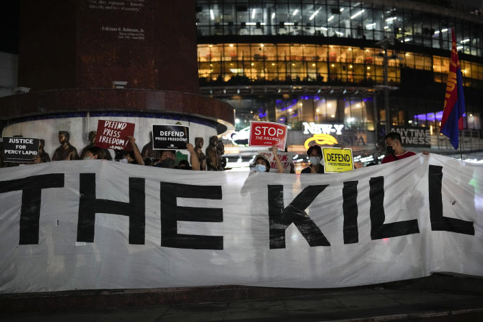 Activists hold slogans as they condemn the killing of Filipino journalist Percival Mabasa during a rally in Quezon city, Philippines on Tuesday Oct. 4, 2022. Motorcycle-riding gunmen killed a longtime radio commentator in metropolitan Manila in the latest attack on a member of the media in the Philippines, considered one of the world's most dangerous countries for journalists. (AP Photo/Aaron Favila)