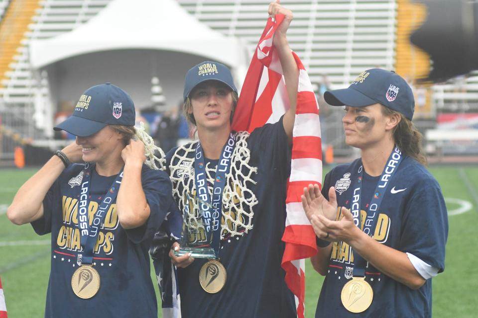 Moorestown native and USA midfielder Marie McCool (middle) scans the stands for her family after winning a gold medal at the 2022 World Lacrosse Women's World Championship