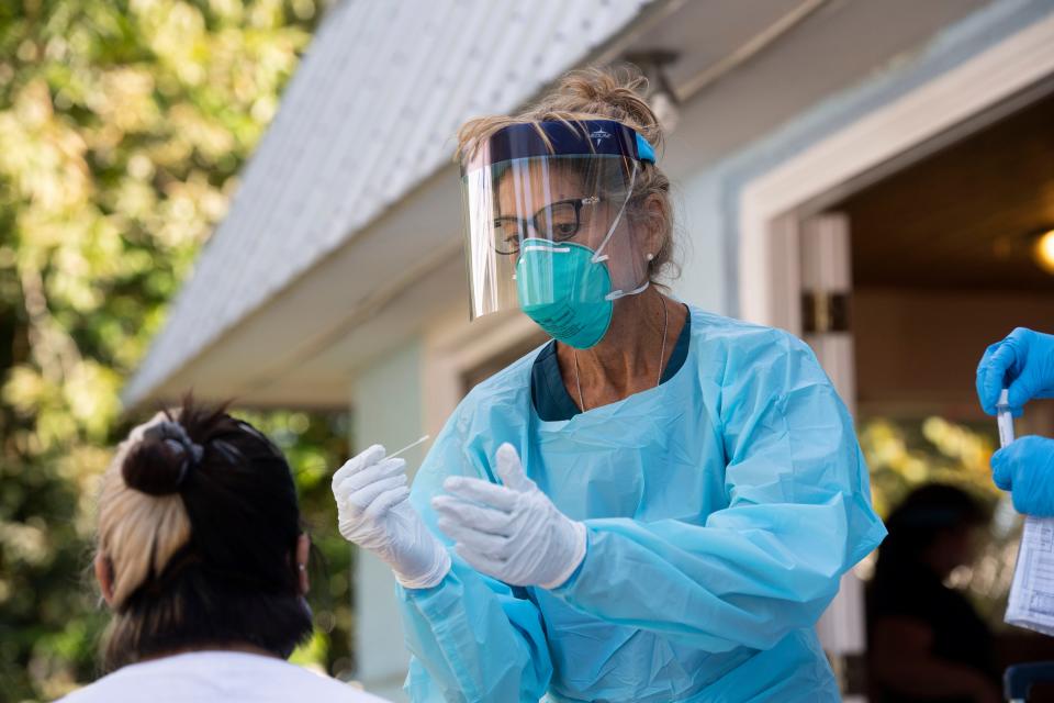 Maureen Agnello, community health nurse for the Martin County Department of Health, prepares to test a resident at St. Lucie Mobile Village for the new coronavirus near Indiantown in Martin County in Florida.