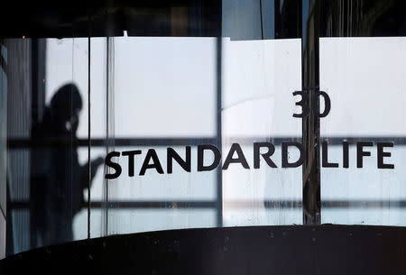 FILE PHOTO: A worker walks inside the Standard Life House in Edinburgh, Scotland February 27, 2014. REUTERS/Russell Cheyne/File Photo