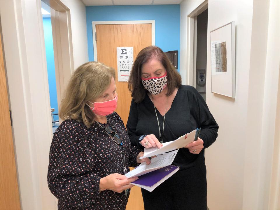 Sally Fabian-Oresic (left), executive director of the Ann Silverman Community Health Clinic at Doylestown Hospital, reviews information with Lisa Kaplan, staff accountant for the clinic.