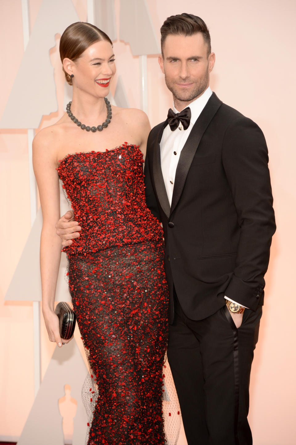 What happens when a Victoria’s Secret model and a rockstar come together? Unbearable hotness. Behati Prinsloo, in Armani Privé, and Adam Levine, in just Armani, are the cheerleader and quarterback couple of this year’s Oscars.