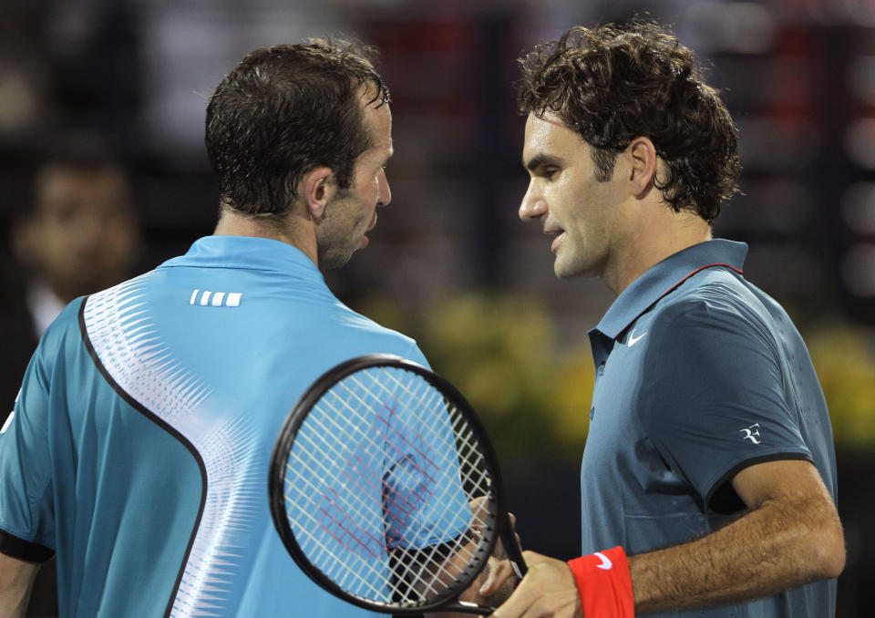 Roger Federer of Switzerland, right, comforts Radek Stepanek of Czech after beating him during the third day of the Dubai Duty Free Tennis Championships in Dubai, United Arab Emirates, Wednesday, Feb. 26, 2014. (AP Photo/Kamran Jebreili)