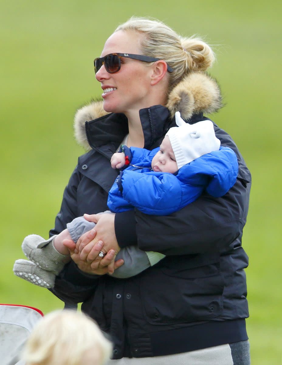 <p>Just a few months after welcoming her first child, Zara was back at the riding arena. Here, she is seen carrying her daughter Mia around at the SYMM International Horse Trials—her first competition back after giving birth.</p>