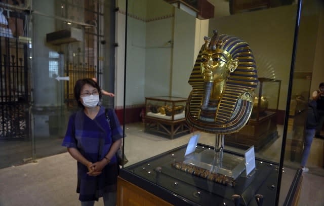 A Japanese tourist visits the golden mask of King Tut on display at the Egyptian Museum in Cairo (Hamada Elrasam/AP)