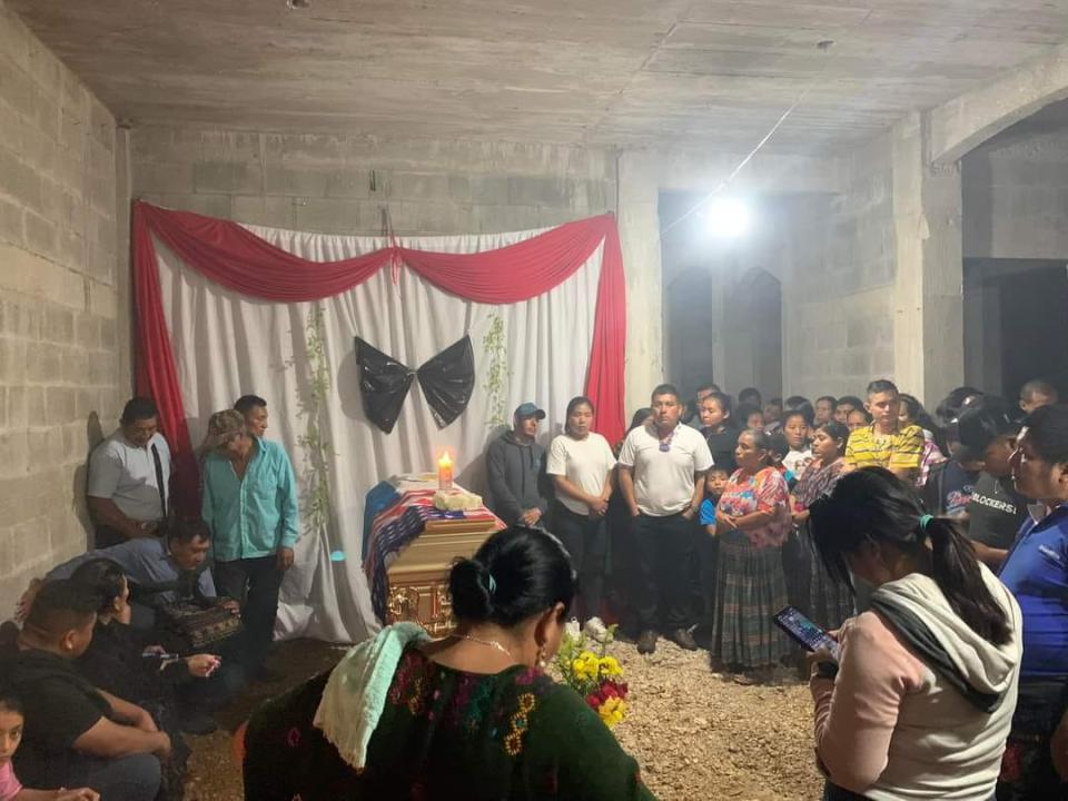 Family members, friends and neighbors of Emmanuel Pop Ba hold a ceremony for him inside of his unfinished house in La Libertad, Petén, Guatemala, on Jan. 1, 2024. Pop Ba was one of four Austin victims of the Dec. 5, 2023, shooting rampage.