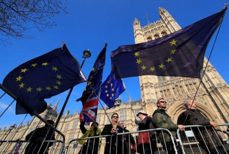 FILE PHOTO: Anti-Brexit protesters hold EU flags as they demonstrate outside the Houses of Parliament in London