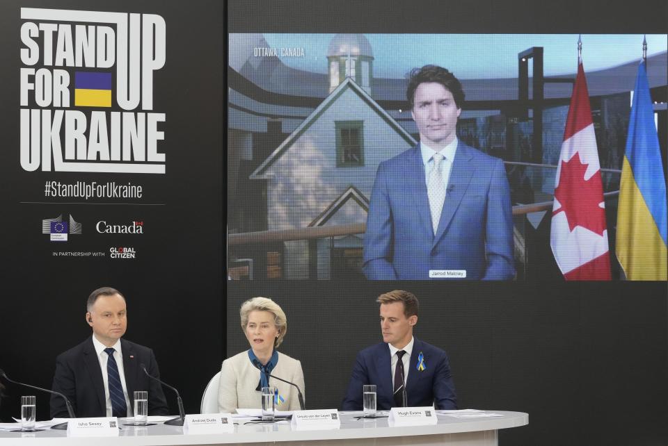 FILE - European Commission President Ursula von der Leyen, center, is flanked by Poland's President Andrzej Duda, left, president at the main event of the "Stand Up for Ukraine" global campaign for pledging funds for Ukraine and its refugees, as Canadian Prime Minister Justin Trudeau attends via video link, at the Palace on the Water, in Warsaw, Poland, April 9, 2022. Ukraine has won victories on the battlefield against Russia but faces a looming challenge on the economic front. So far, the U.S. has been the leading donor, giving $15.2 billion in financial assistance and $52 billion in overall aid, including humanitarian and military assistance, through Oct. 3, according to the Ukraine Support Tracker at the Kiel Institute for the World Economy. EU institutions and member countries have committed $29.2 billion. (AP Photo/Czarek Sokolowski, File)