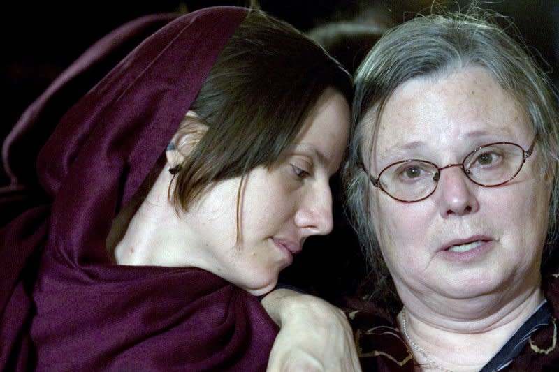 Sarah Shourd (L) listens to her mother Nora speak to the media during her visit north of Tehran, Iran on May 20, 2010. On September 14, 2010, Shourd, imprisoned in Iran on charges of espionage for more than a year after she and two male companions were accused of illegally crossing into Iranian territory, was released on $500,000 bail. File Photo by Maryam Rahmanian/UPI