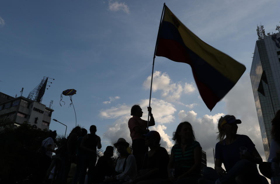 Opponents to Venezuela's President Nicolas Maduro hold a vigil for those killed in street fighting over the past week in Caracas, Venezuela, Sunday, May 5, 2019. Opposition leader Juan Guaidó called in vain for a military uprising to overthrow Maduro, and five people were killed in clashes between protesters and police. (AP Photo/Martin Mejia)