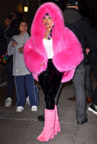 <p>James Devaney/GC Images</p> Nicki Minaj arrives at "The Late Show With Stephen Colbert" in a hot pink outfit