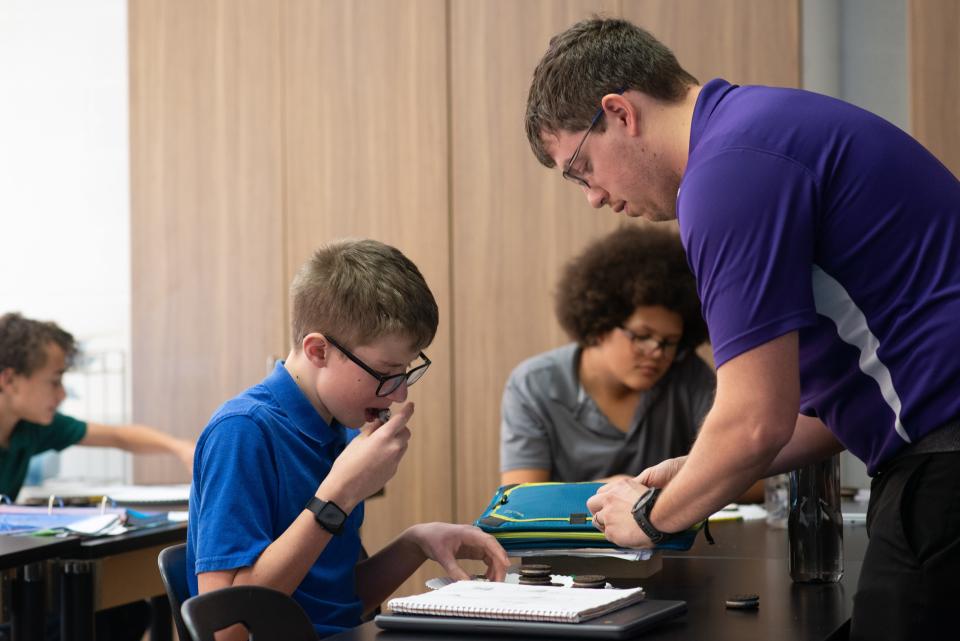Joshua Grass shows seventh-grader Oliver Snethen a twisting technique to open up Oreo cookies during a lab project over moon phases. Since only portions of the cookies are needed, Snethen and other classmates got to enjoy a treat while learning.