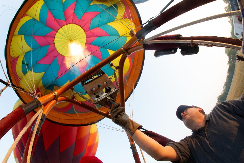 A blast of hot air helps to lift Tony Goodnow's hot air balloon, Hocus Pocus, igniting vaporized propane Thursday morning.