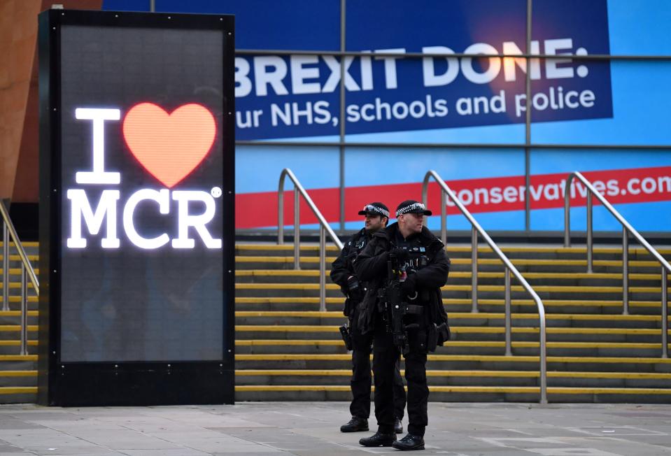 Armed British police officers hold their weapons as they stand on duty outside the annual Conservative Party conference at the Manchester Central convention complex in Manchester, north-west England on September 30, 2019. (Photo by Paul ELLIS / AFP)        (Photo credit should read PAUL ELLIS/AFP/Getty Images)