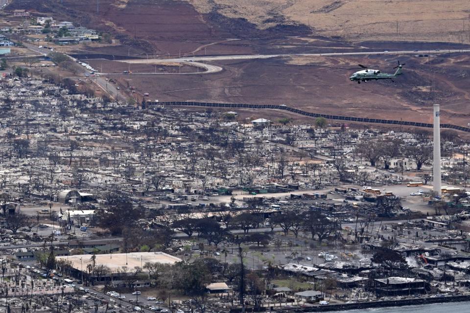 Marine One, carrying US President Joe Biden, flies above wildfire damage in Lahaina on the island of Maui, in Hawaii on August 21, 2023. The Bidens are expected to meet with first responders, survivors, and local officials following deadly wildfires in Maui.