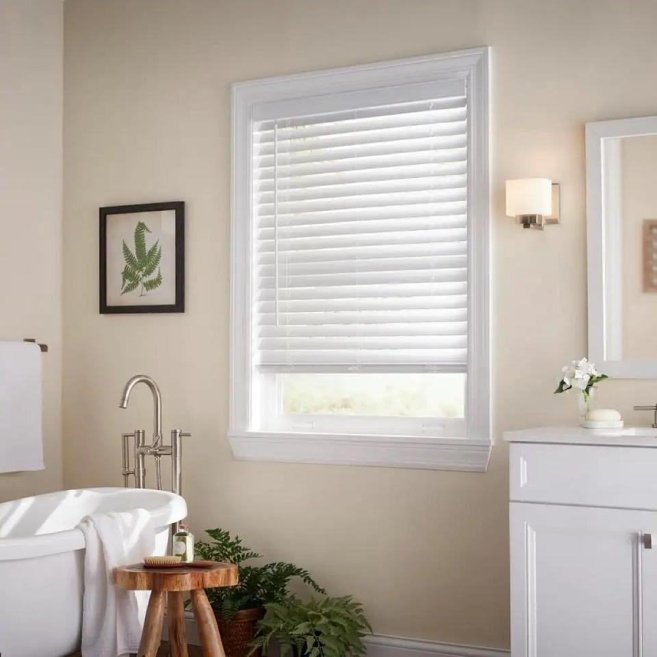 Bathroom window with partially open Venetian blinds