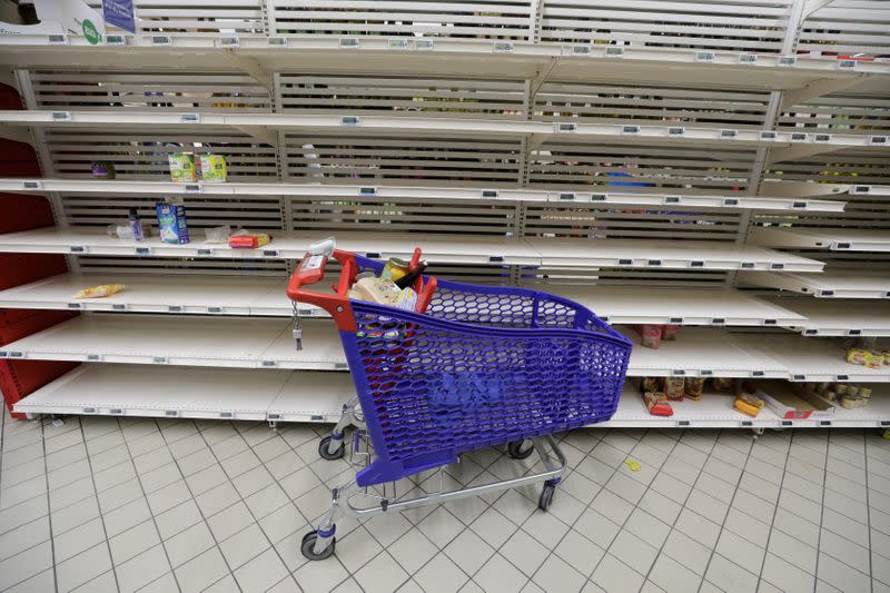 A view shows empty shelves at a Carrefour supermarket as people began stockpiling food in Monaco