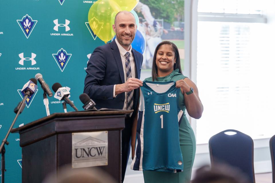 Nicole Woods (R) is introduced as UNCW's 12th women's basketball coach in the school's history by UNCW Athletic Director Michael Oblinger (L) at a press conference on Monday, April 17, 2023.