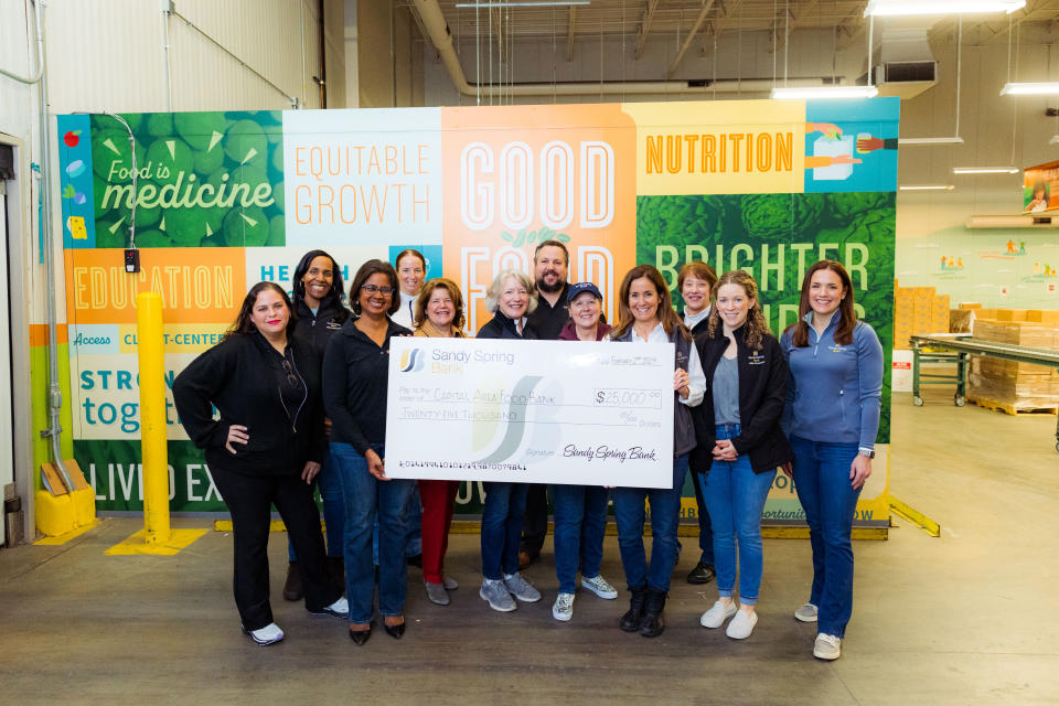 Sandy Spring Bank volunteers with Radha Muthiah, President and Chief Executive Officer of Capital Area Food Bank.