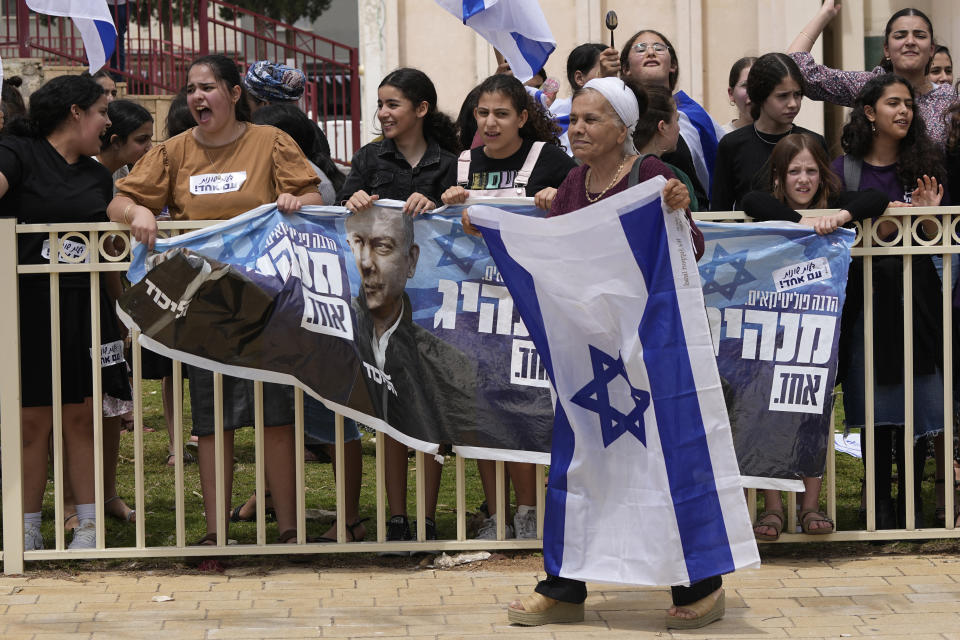 Supporters of Israeli Prime Minister Benjamin Netanyahu's government plans to overhaul the judicial system protest ahead of the weekly cabinet meeting in Sderot, Israel, near the border with the Gaza Strip, Thursday, April 20, 2023. (AP Photo/Tsafrir Abayov)