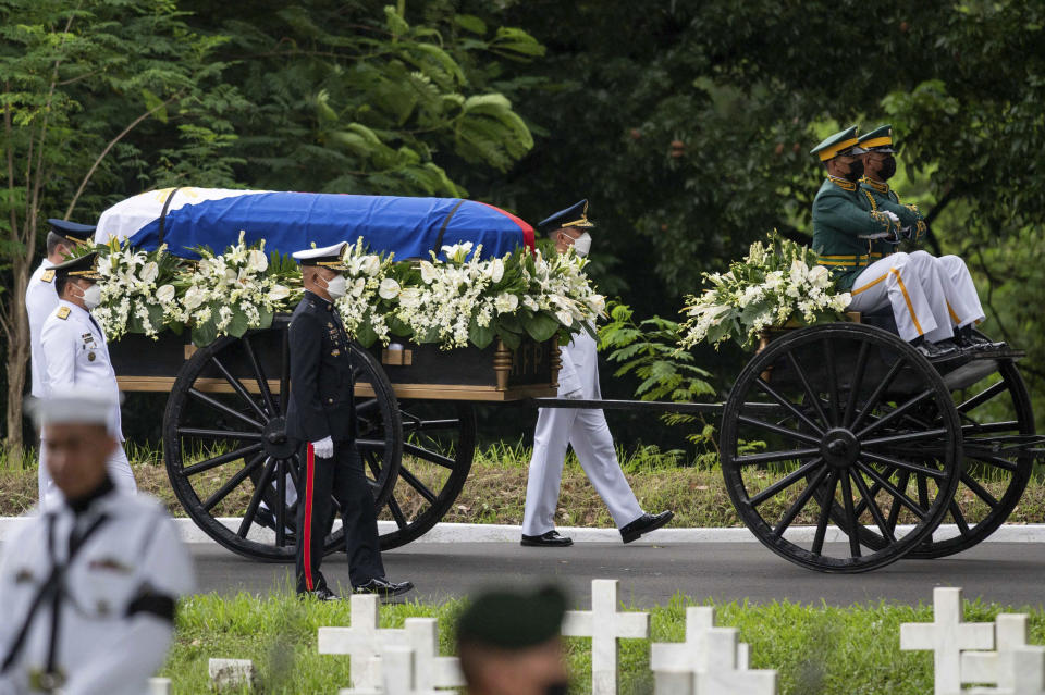 Soldiers transport the casket carrying the urn of the late Philippine President Fidel Ramos during his state funeral at the Heroes' Cemetery in Taguig City, Philippines, Tuesday, Aug. 9, 2022. Ramos was laid to rest in a state funeral Tuesday, hailed as an ex-general, who backed then helped oust a dictatorship and became a defender of democracy and can-do reformist in his poverty-wracked Asian country. (Lisa Marie David/Pool Photo via AP)