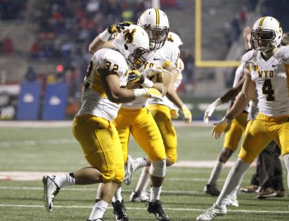 Nov 1, 2014; Fresno, CA, USA; Wyoming Cowboys running back Joshua Tapscott (32) is congratulated by free safety Xavier Lewis (18) after scoring a touchdown against the Fresno State Bulldogs in the fourth quarter at Bulldog Stadium. The Cowboys defeated the Bulldogs 45-17. (Cary Edmondson-USA TODAY Sports)