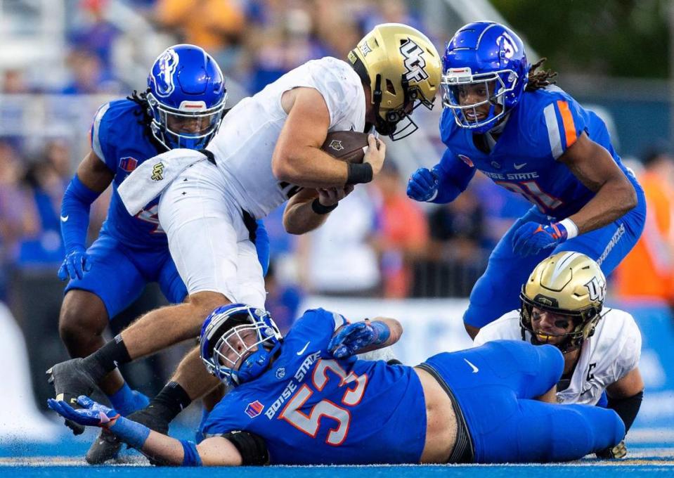 UCF quarterback John Rhys Plumlee tries to convert on 3rd down, but Boise State linebacker Marco Notarainni and safety Zion Washington stop the run, Saturday, Sept. 9, 2023.