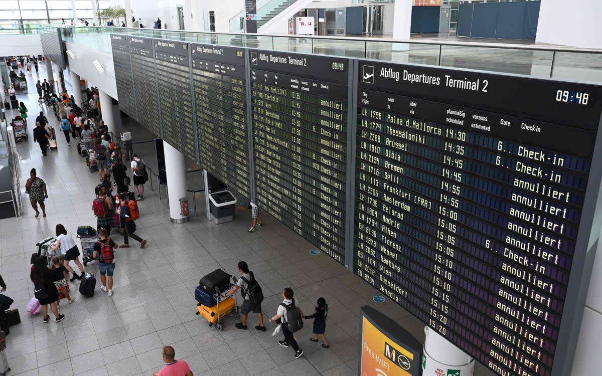 Passengers queue up at Munich Airport (AFP via Getty Images)