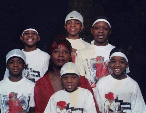 Domonique Holley-Grisham, in a photo with his mother and five brothers, disappeared in 2009 at the age of 16. Pictured are, back row, left to right: Marcus Holley-Grisham, Domonique, Jessie Holley-Grisham III; and front row, left to right: Jaquan Holley-Grisham, Mozell Jones-Grisham, Antonio Holley-Grisham, James Holley-Grisham.