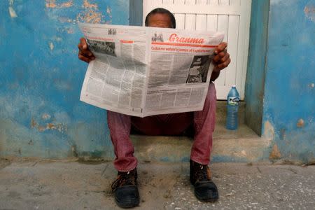 A man reads the daily newspaper Granma in Havana, Cuba, July 21, 2018. REUTERS/ Stringer