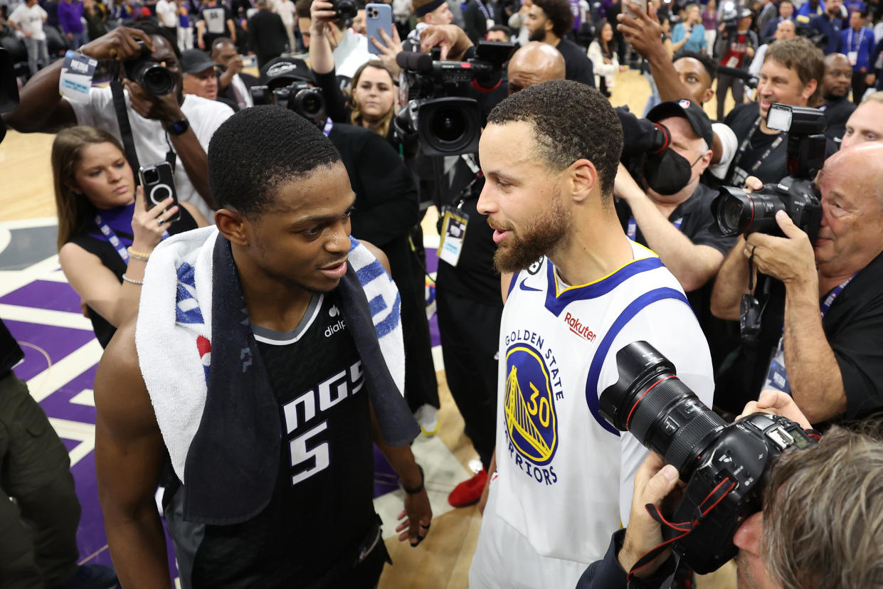 SACRAMENTO, CALIFORNIA - APRIL 30: Stephen Curry #30 of the Golden State Warriors talks with De'Aaron Fox #5 of the Sacramento Kings after the Warriors defeated the Kings 120-100 in game seven of the Western Conference First Round Playoffs at Golden 1 Center on April 30, 2023 in Sacramento, California. NOTE TO USER: User expressly acknowledges and agrees that, by downloading and or using this photograph, User is consenting to the terms and conditions of the Getty Images License Agreement. (Photo by Ezra Shaw/Getty Images)