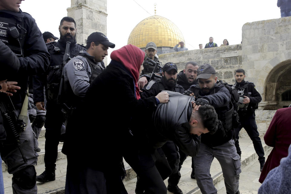 Israeli police arrests a Palestinian in front of the Dome of the Rock mosque in Jerusalem, Monday, Feb. 18, 2019. Israeli police officers have arrested several Palestinians for "causing a disturbance" at a flashpoint Jerusalem holy site. The men took part in a prayer protest Monday outside a section of the Temple Mount that has been closed by Israeli court order for over a decade. (AP Photo/Mahmoud Illean)