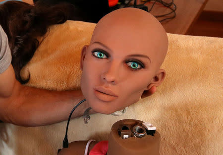 Catalan nanotechnology engineer Sergi Santos holds the head of Samantha, a sex doll packed with artificial intelligence providing her the capability to respond to different scenarios and verbal stimulus, in his house in Rubi, north of Barcelona, Spain, March 31, 2017. REUTERS/Albert Gea