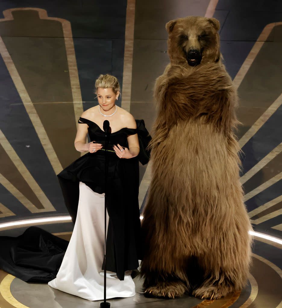 HOLLYWOOD, CALIFORNIA - MARCH 12: (L-R) Elizabeth Banks and Cocaine Bear speak onstage during the 95th Annual Academy Awards at Dolby Theatre on March 12, 2023 in Hollywood, California. (Photo by Kevin Winter/Getty Images)