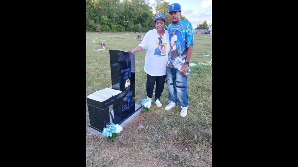 Sherry Paige (left) and Shawntele Gray (right) stand next to Shawndele Gray’s headstone. Paige said she’ll be buried next to him.