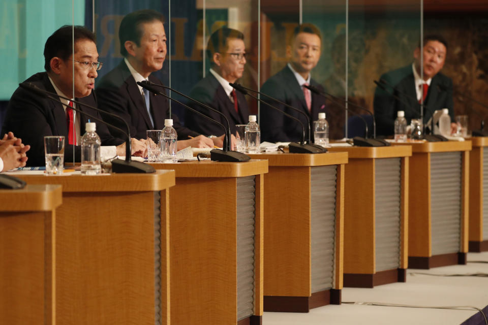 Prime Minister and governing Liberal Democratic Party President Fumio Kishida, left, speaks during a debate session with other leaders of Japan's main political parties ahead of the Oct. 31, 2021 lower house election at the Japan National Press Club in Tokyo Monday, Oct. 18 , 2021. (Issei Kato/Pool Photo via AP)