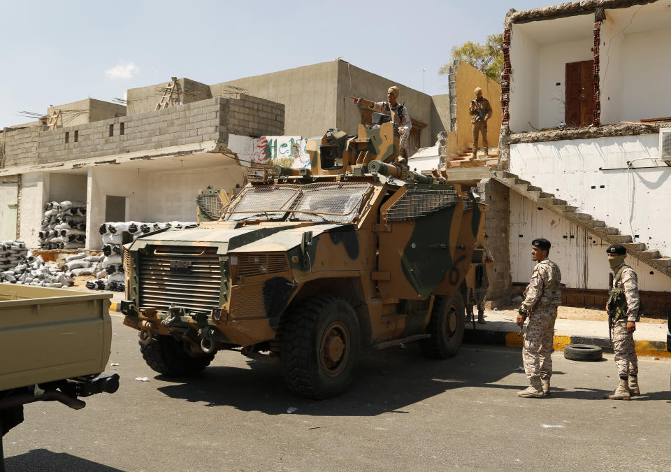 Libyan army forces and vehicles are stationed in a street in the country’s capital of Tripoli on Friday, July 22 2022. One of Libya’s rival governments on Friday called on militias to stop fighting, after clashes broke out in the country’s capital, Tripoli overnight, killing at least one civilian and forcing around 200 people to flee the area.(AP Photo/Yousef Murad)