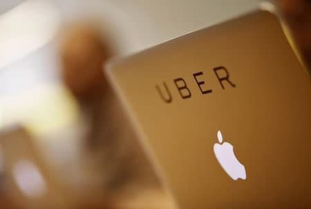 An employee works inside the office of U.S. online cab-hailing company Uber, on the outskirts of New Delhi, India, April 24, 2015. REUTERS/Anindito Mukherjee